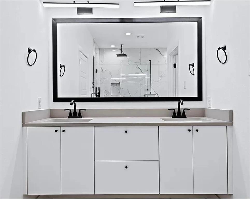 1605 Logan Street Fort Worth, TX 76104 - Photo 14 of 17 a bathroom with a sink and a mirror