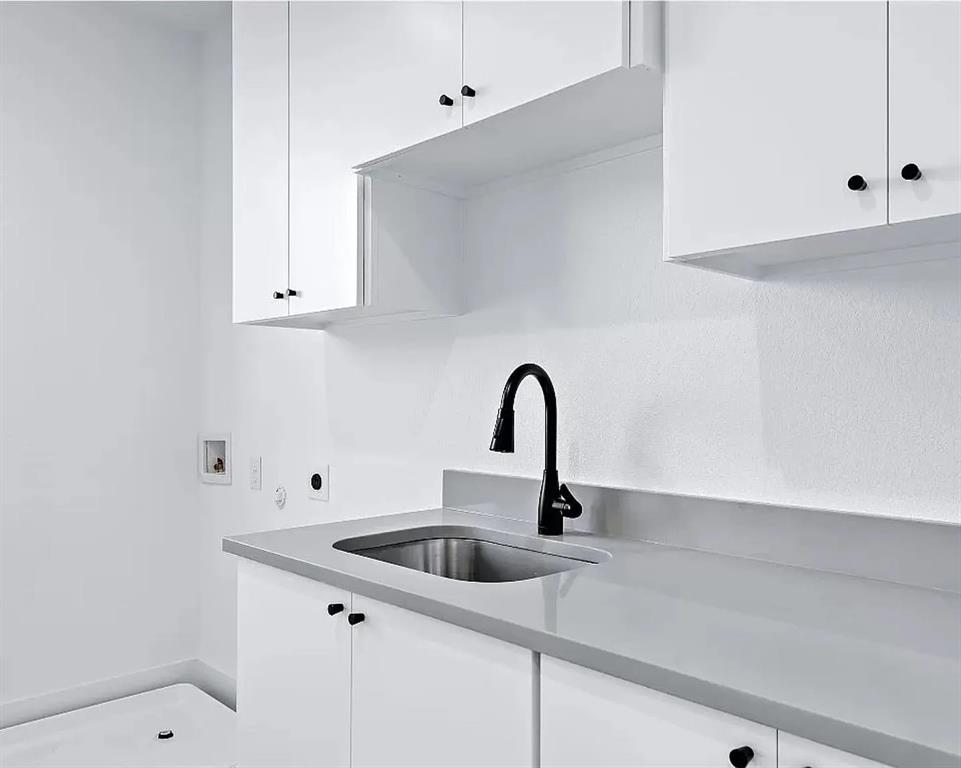 1605 Logan Street Fort Worth, TX 76104 - Photo 17 of 17 a close view of a sink a faucet and appliance in the kitchen