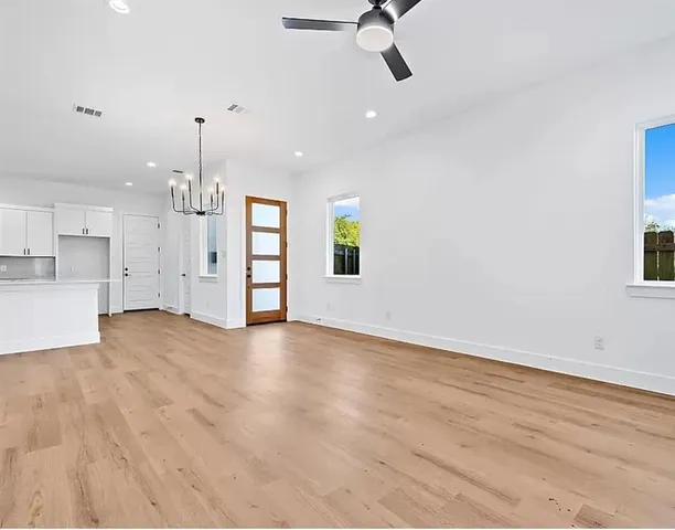 a view of an empty room with a kitchen