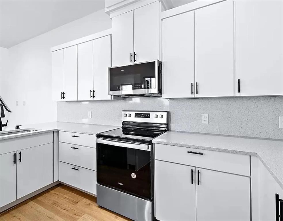 1605 Logan Street Fort Worth, TX 76104 - Photo 8 of 17 a kitchen with appliances a sink and cabinets
