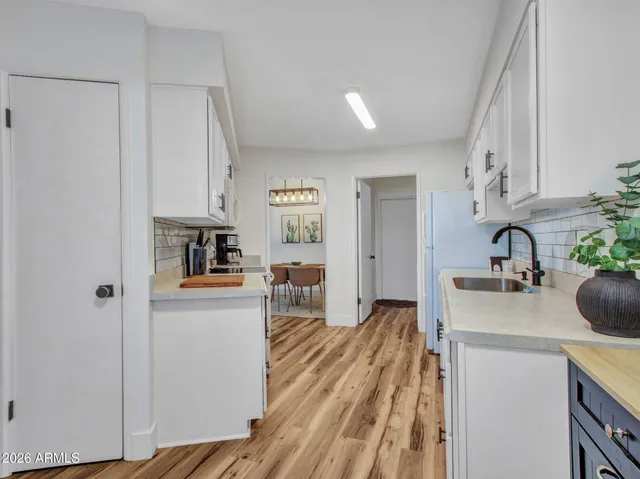 a kitchen with a sink a stove and cabinets