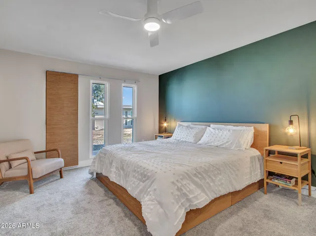 a bedroom with a bed and a lamp