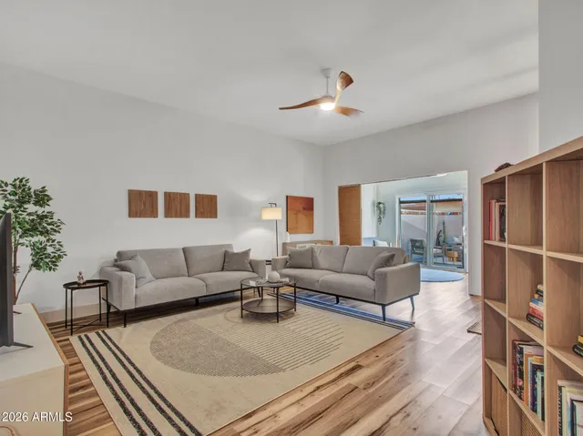 a living room with furniture and a wooden floor