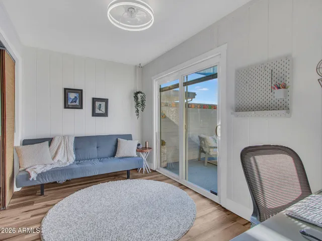a living room with furniture and a mirror