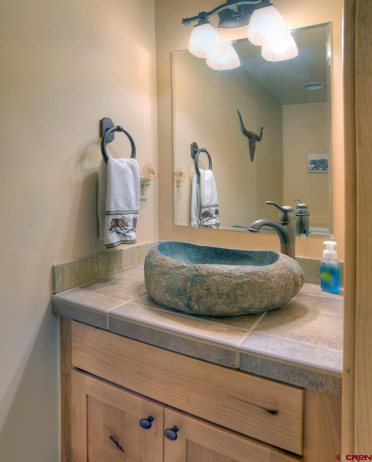 67 Travertine Trail, Unit 67 Durango, CO 81301 - Photo 16 of 35 a bathroom with a sink and mirror