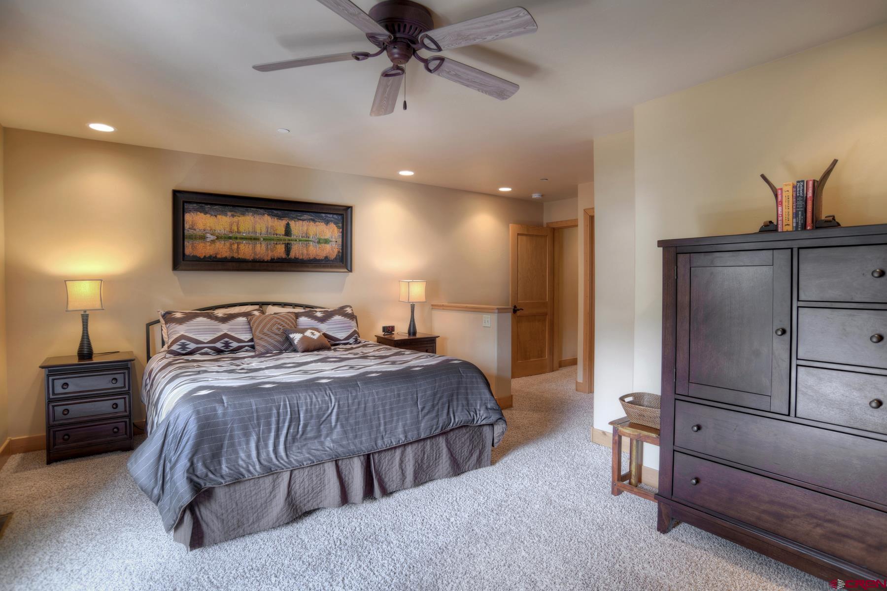 67 Travertine Trail, Unit 67 Durango, CO 81301 - Photo 19 of 35 a bedroom with bed and a chandelier