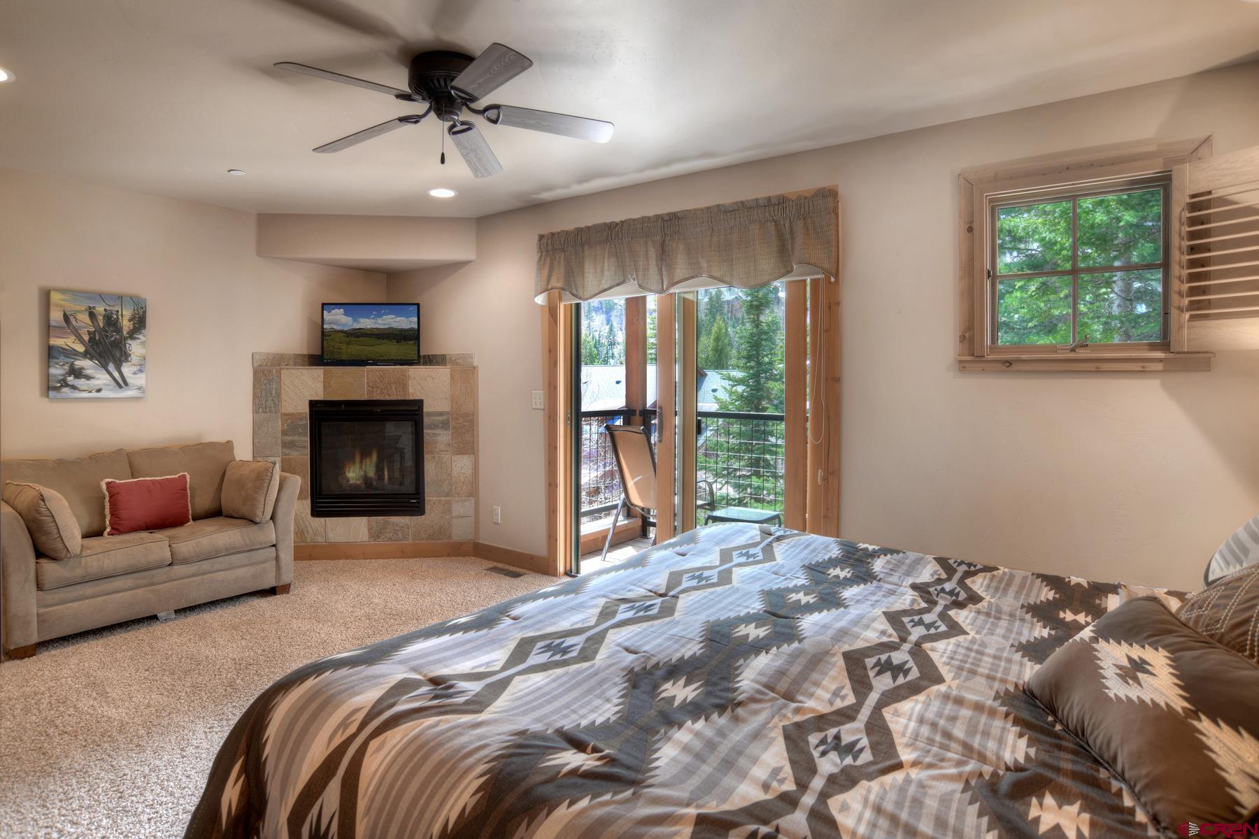 67 Travertine Trail, Unit 67 Durango, CO 81301 - Photo 20 of 35 a bedroom with a large bed and a couch