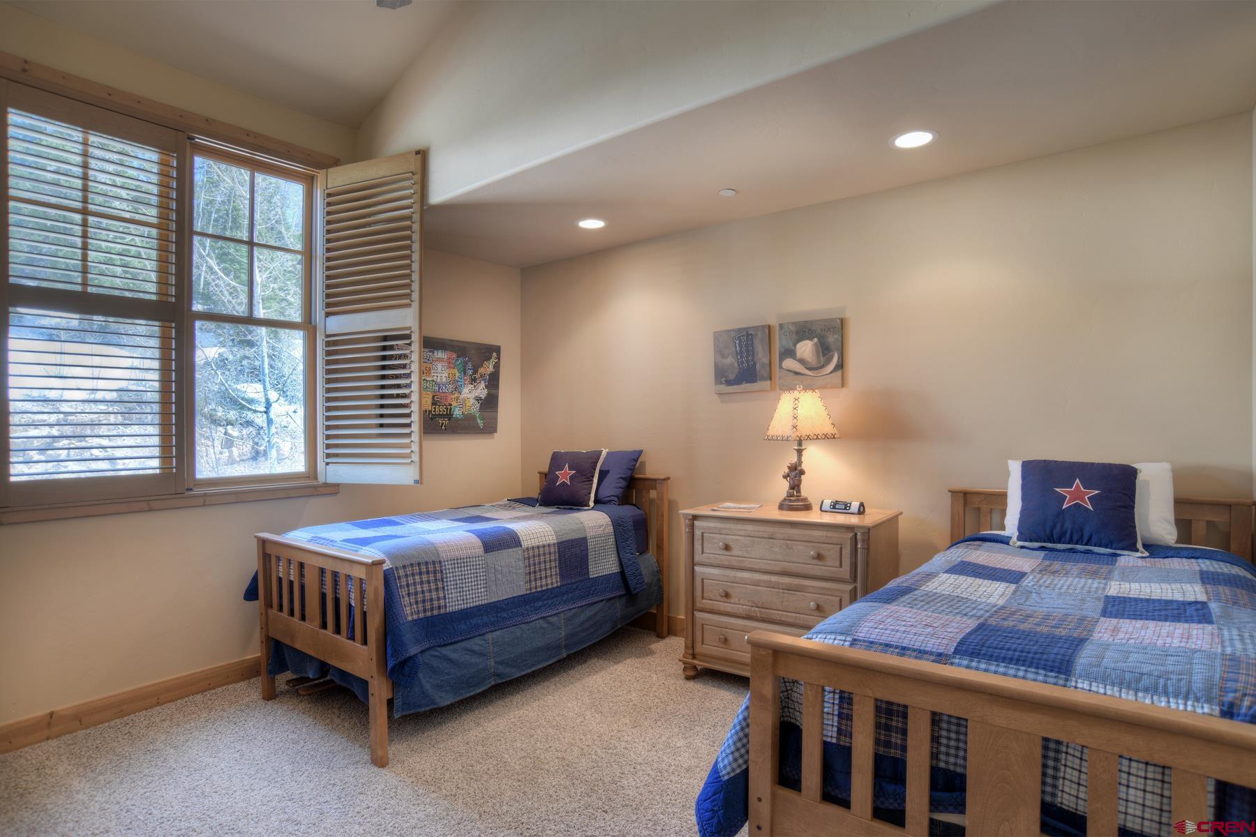 67 Travertine Trail, Unit 67 Durango, CO 81301 - Photo 25 of 35 a bedroom with a bed and a table