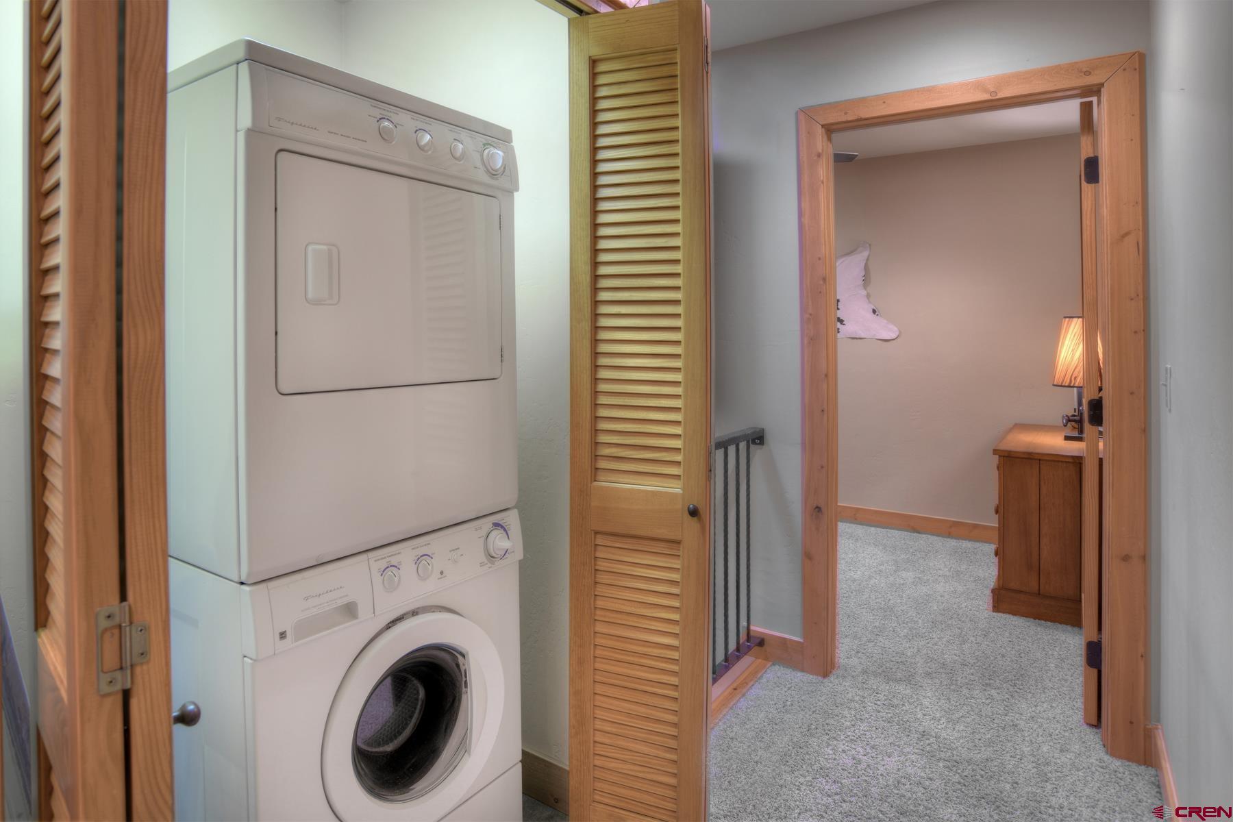 67 Travertine Trail, Unit 67 Durango, CO 81301 - Photo 30 of 35 a view of a hallway with washer and dryer