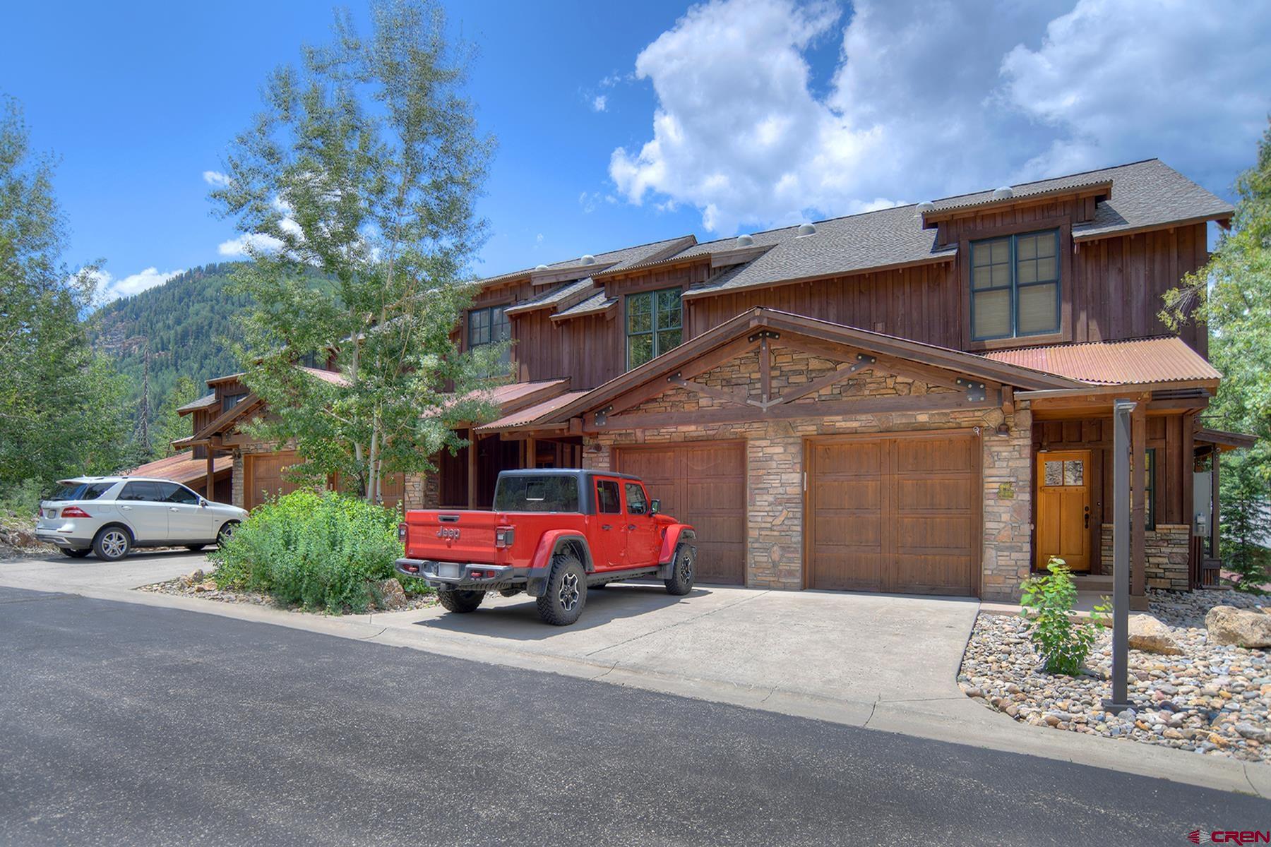 67 Travertine Trail, Unit 67 Durango, CO 81301 - Photo 4 of 35 a front view of a house with garden and parking