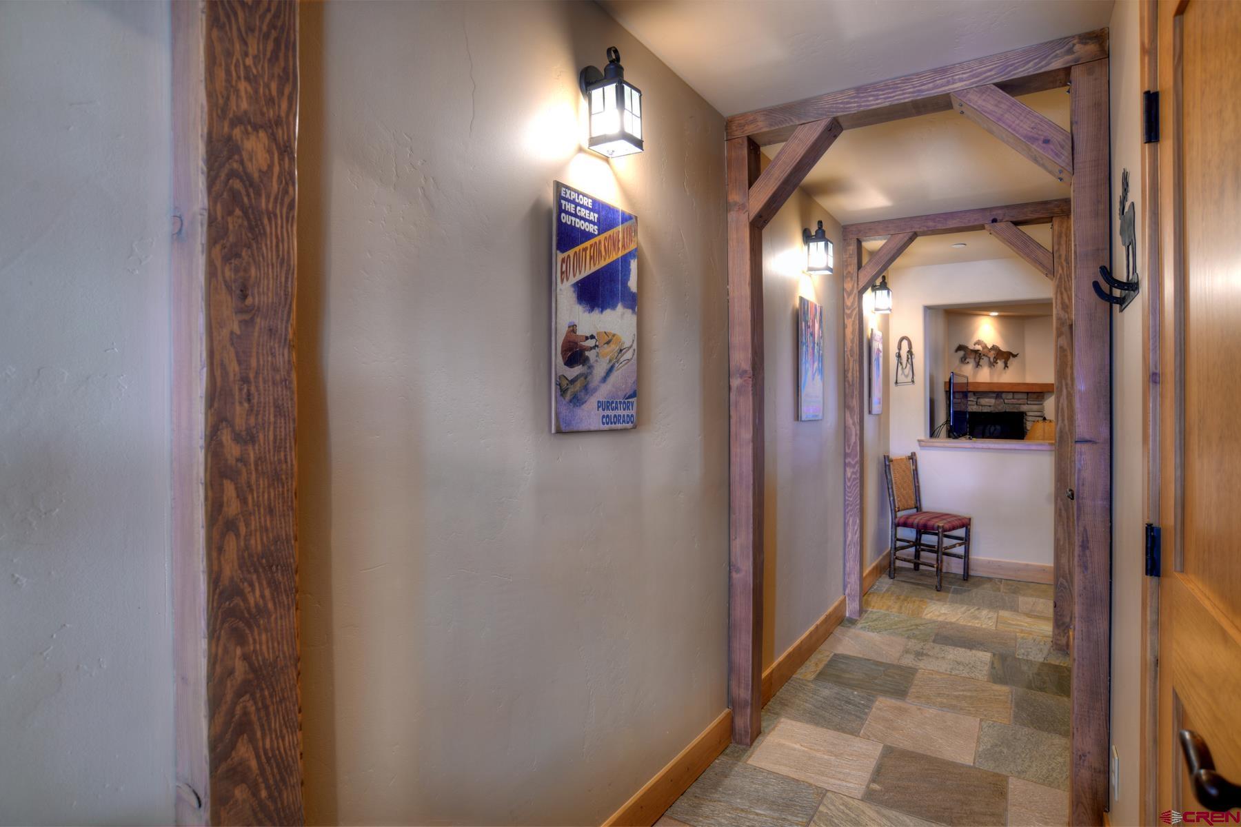 67 Travertine Trail, Unit 67 Durango, CO 81301 - Photo 6 of 35 a view of hallway with livingroom and a chandelier
