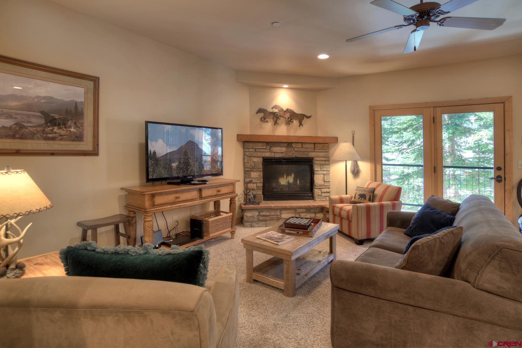 67 Travertine Trail, Unit 67 Durango, CO 81301 - Photo 7 of 35 a living room with furniture and a flat screen tv