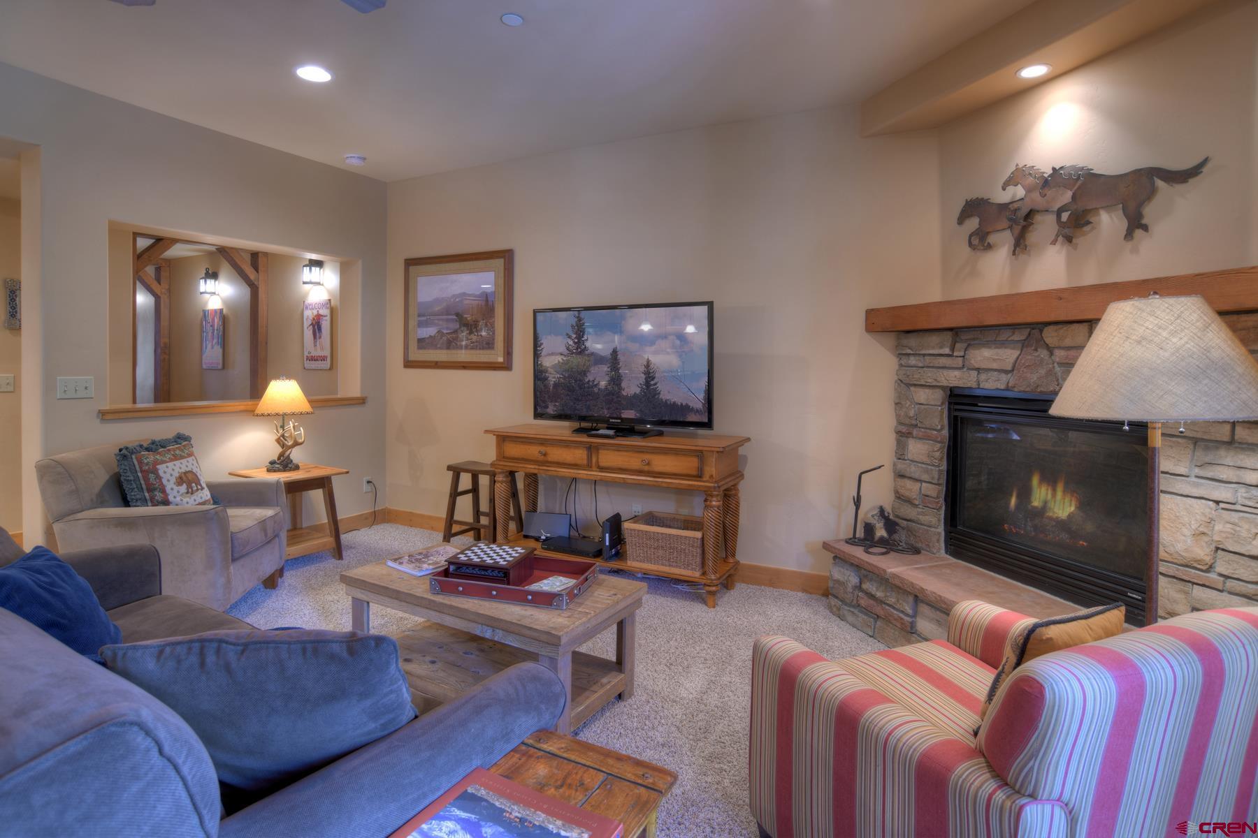 67 Travertine Trail, Unit 67 Durango, CO 81301 - Photo 10 of 35 a living room with furniture and a fireplace