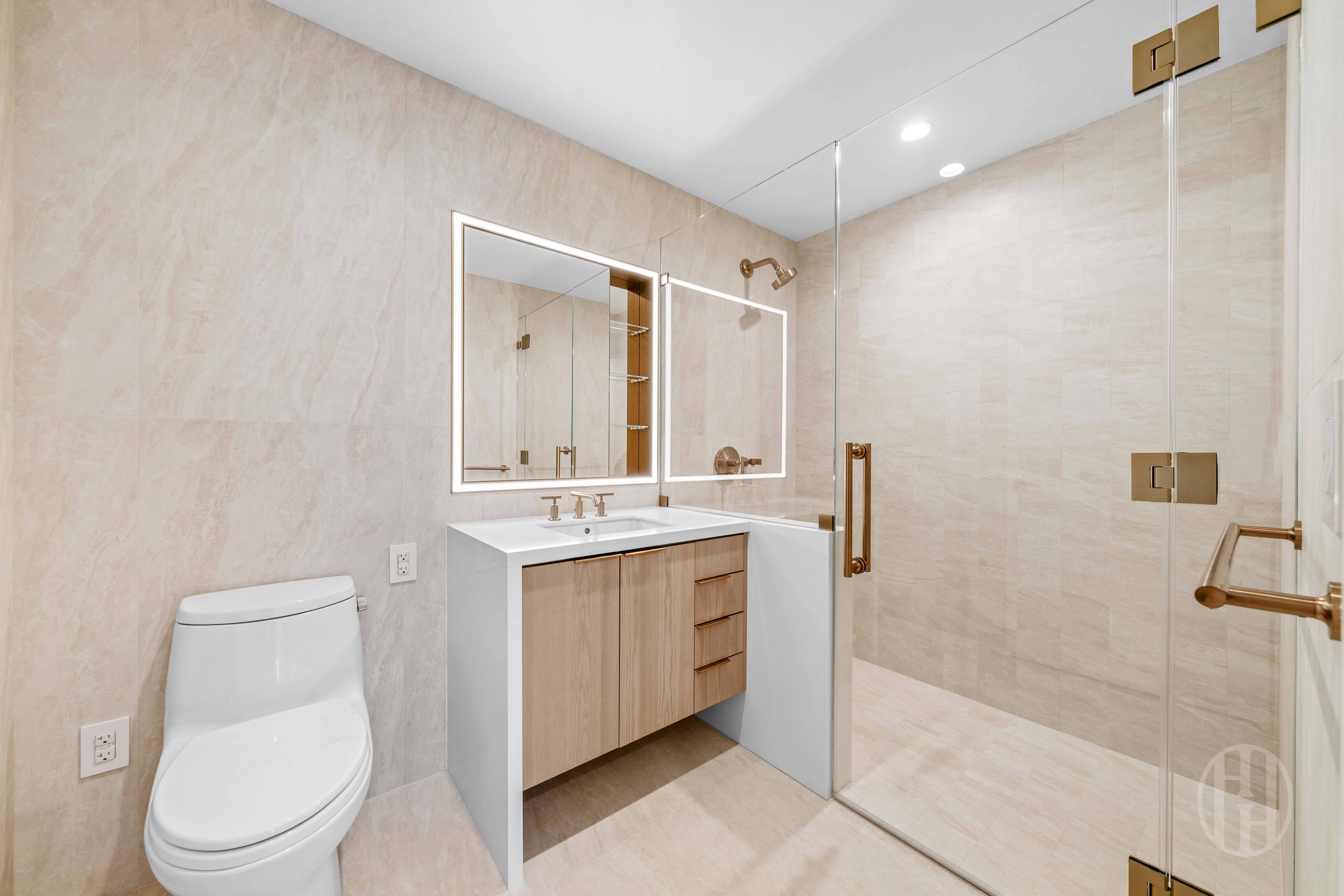 3 Court Square, Unit 5601 Queens, NY 11101 - Photo 10 of 20 a bathroom with a toilet a sink a mirror and vanity