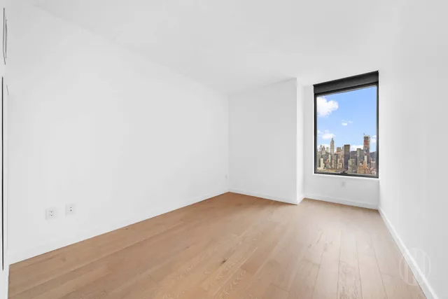 a bedroom with bed and a large window