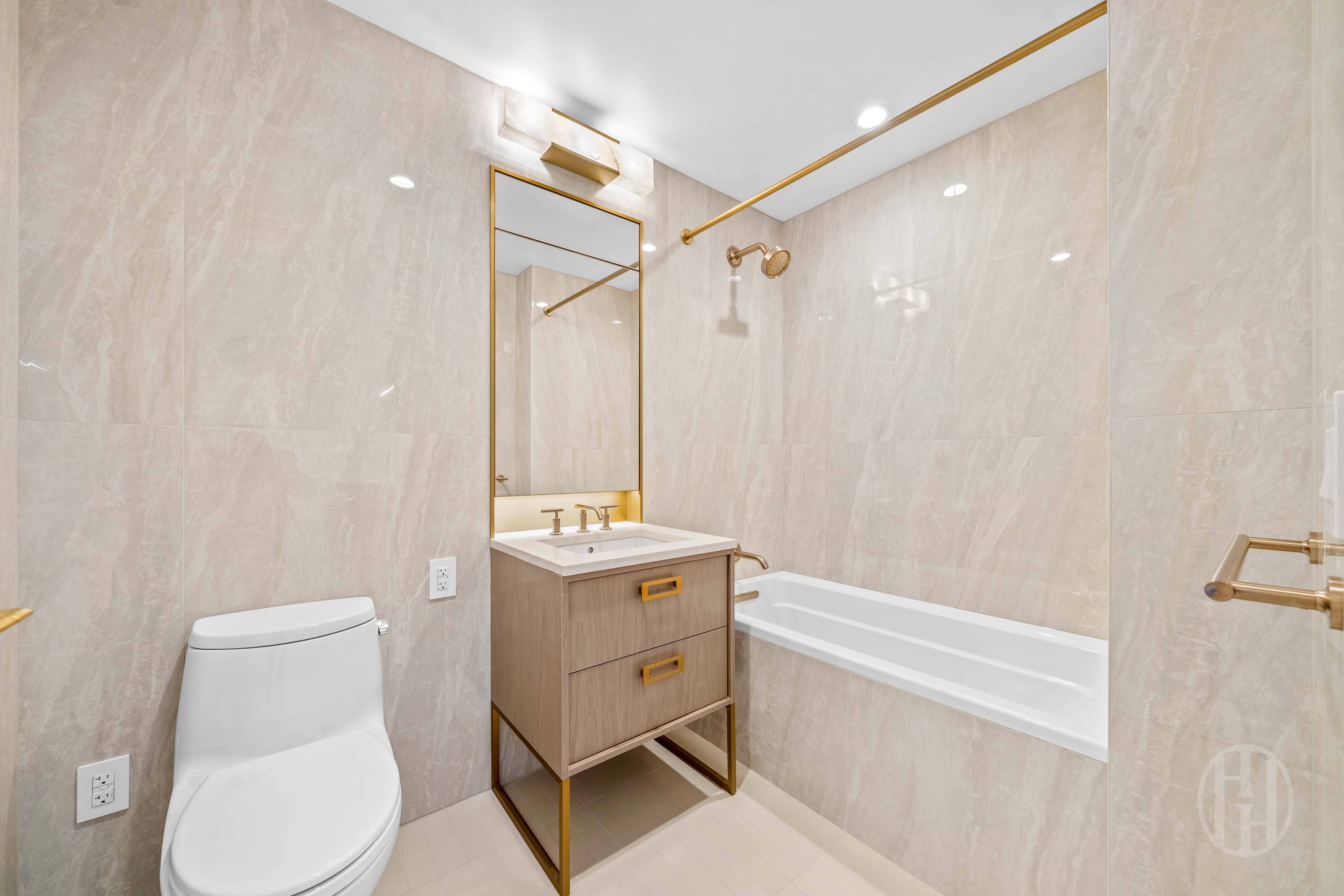 3 Court Square, Unit 5601 Queens, NY 11101 - Photo 14 of 20 a bathroom with a toilet a sink and bathtub