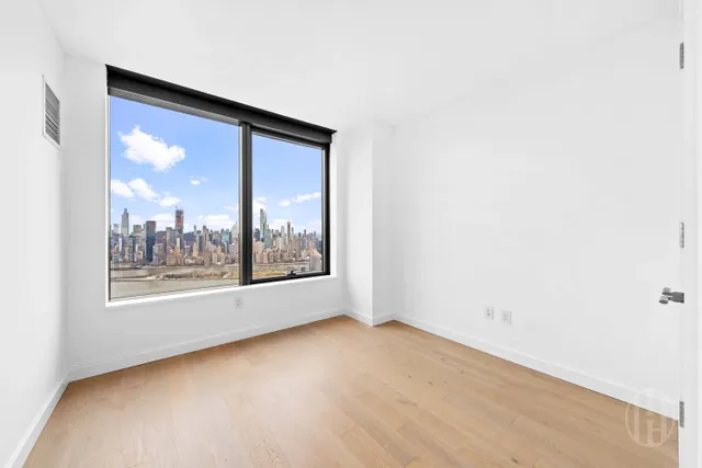 a bedroom with a bed and a large window