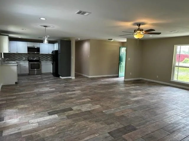 a view of a kitchen with a sink and chandelier fan