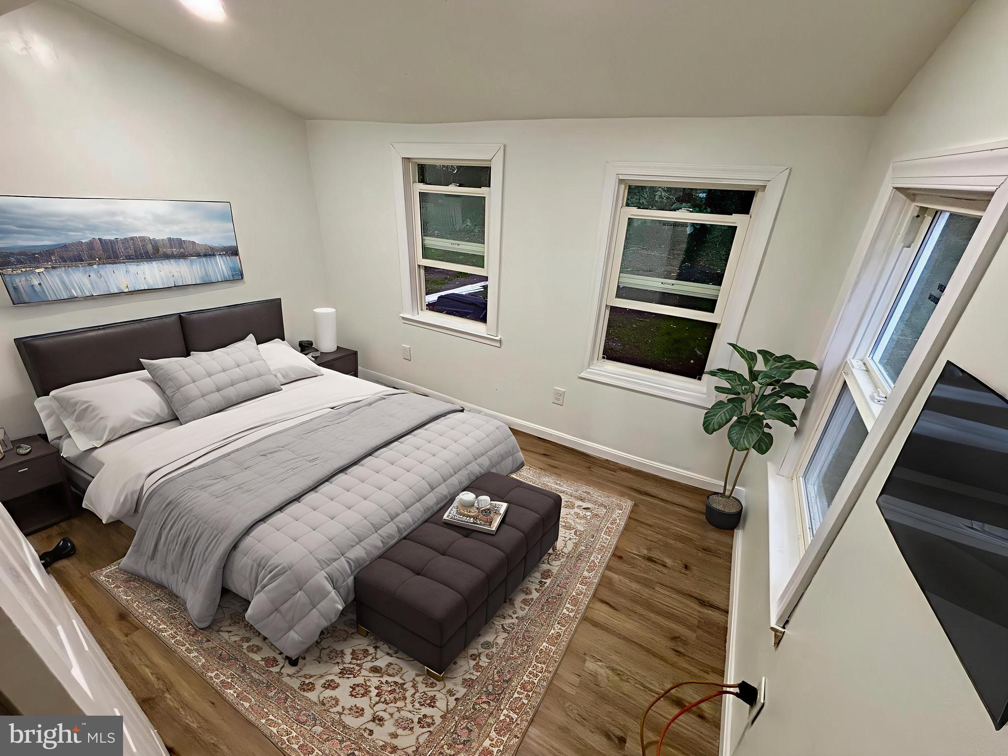 802 Fairmount Avenue Cambridge, MD 21613 - Photo 16 of 16 a bedroom with a bed wooden floor and a window