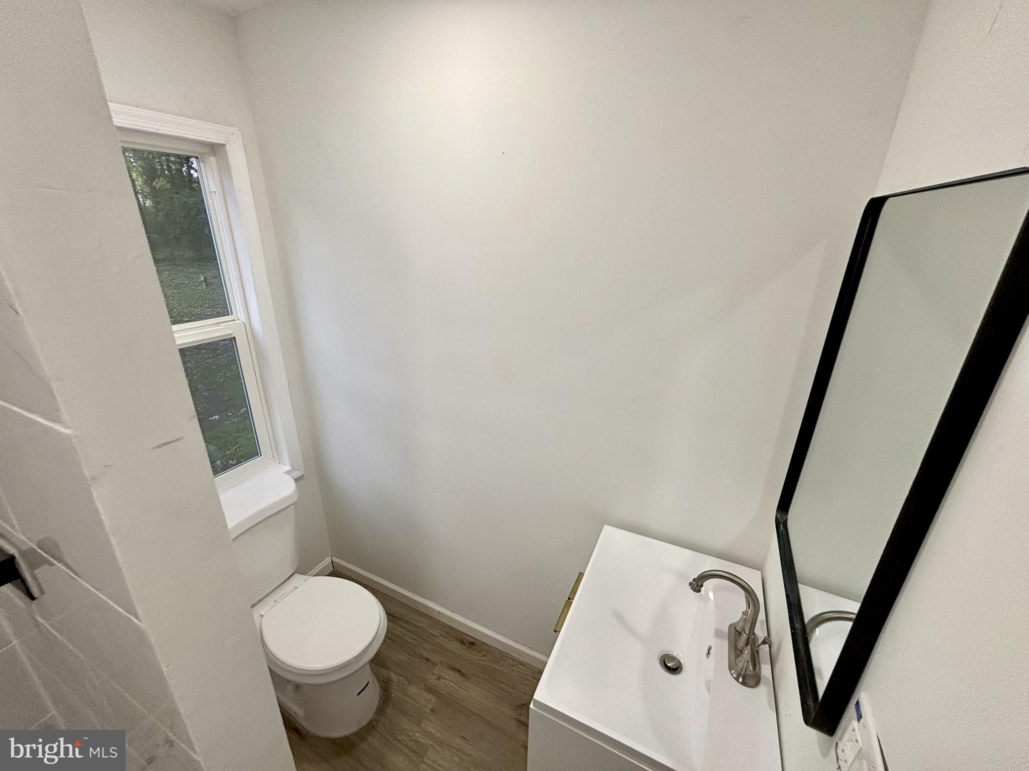 802 Fairmount Avenue Cambridge, MD 21613 - Photo 8 of 16 a white toilet sitting next to a bathroom sink