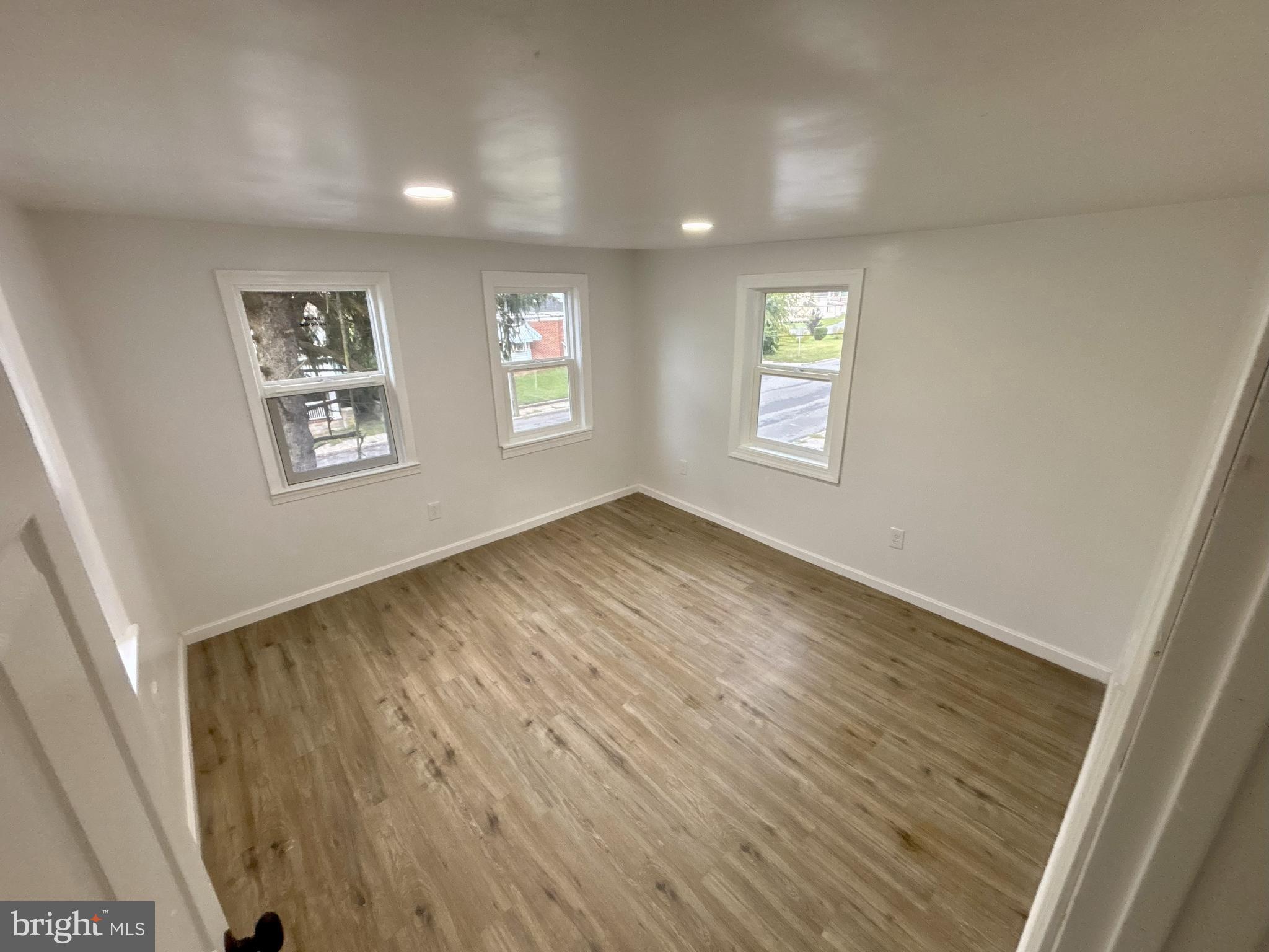 802 Fairmount Avenue Cambridge, MD 21613 - Photo 9 of 16 a view of an empty room with a window and wooden floor
