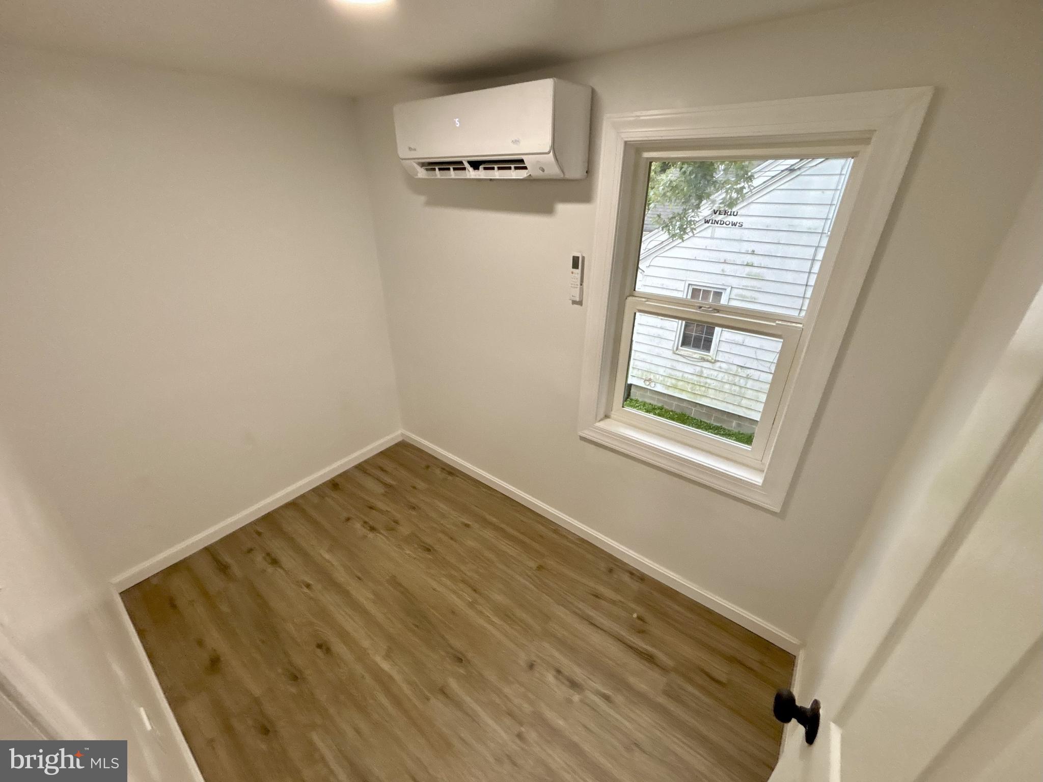 802 Fairmount Avenue Cambridge, MD 21613 - Photo 10 of 16 a view of an empty room with wooden floor and a window