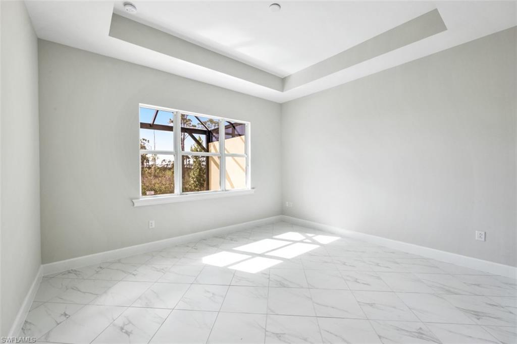 6435 Negril Isle Drive Naples, FL 34113 - Photo 17 of 35 an empty room with windows