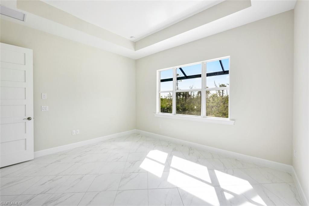 6435 Negril Isle Drive Naples, FL 34113 - Photo 19 of 35 a view of an empty room with a window
