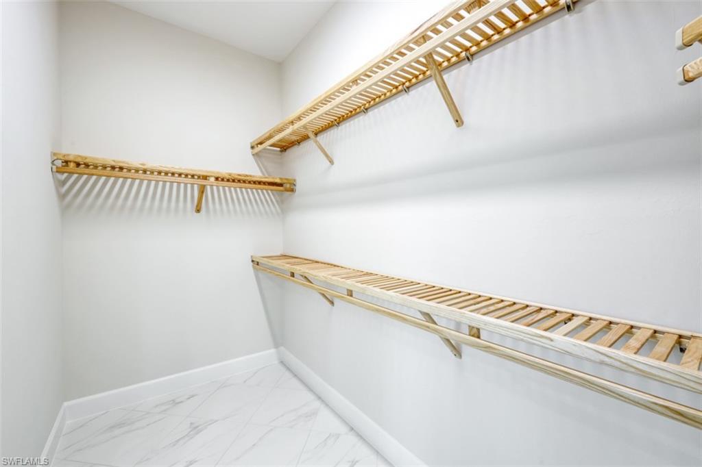 6435 Negril Isle Drive Naples, FL 34113 - Photo 20 of 35 a view of a room with rack on the wall