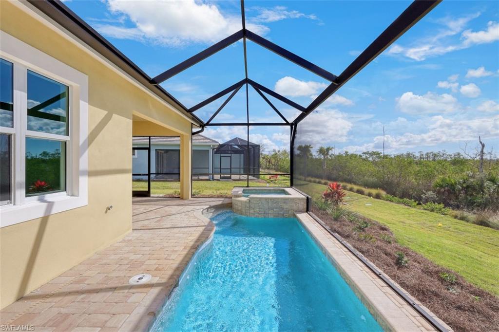 6435 Negril Isle Drive Naples, FL 34113 - Photo 2 of 35 a view of a house with a swimming pool