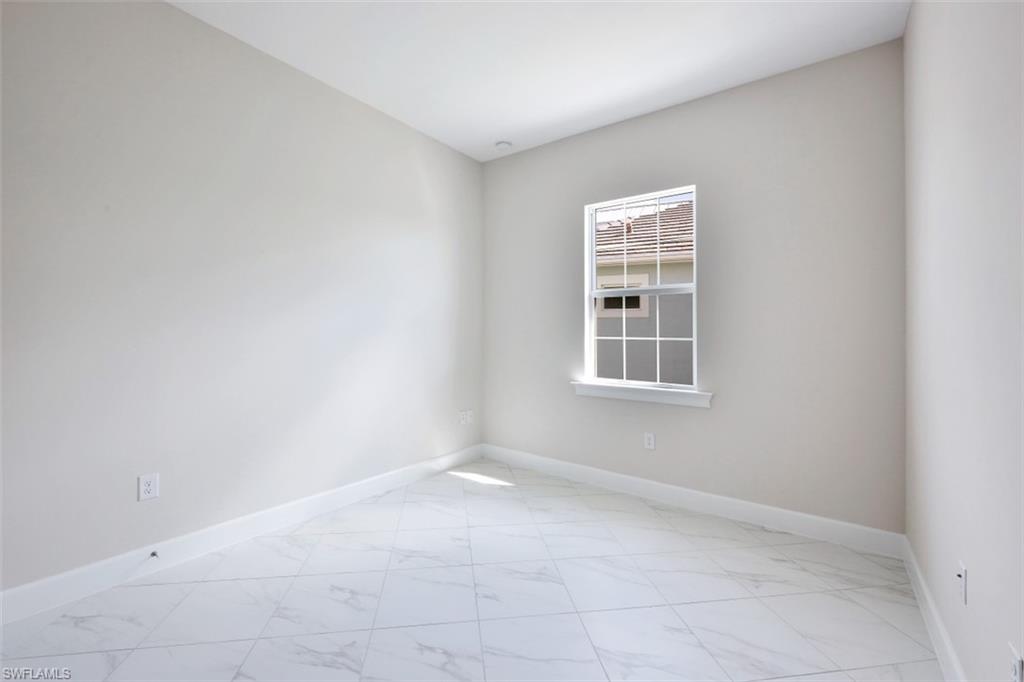 6435 Negril Isle Drive Naples, FL 34113 - Photo 23 of 35 an empty room with windows