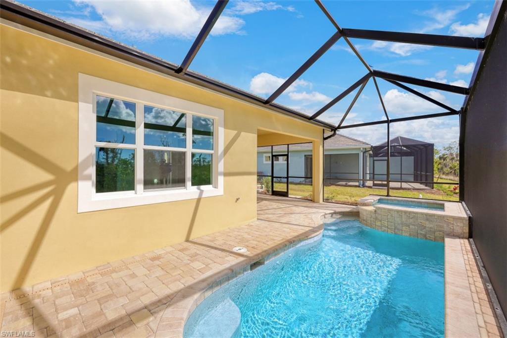 6435 Negril Isle Drive Naples, FL 34113 - Photo 31 of 35 a view of swimming pool with seating area