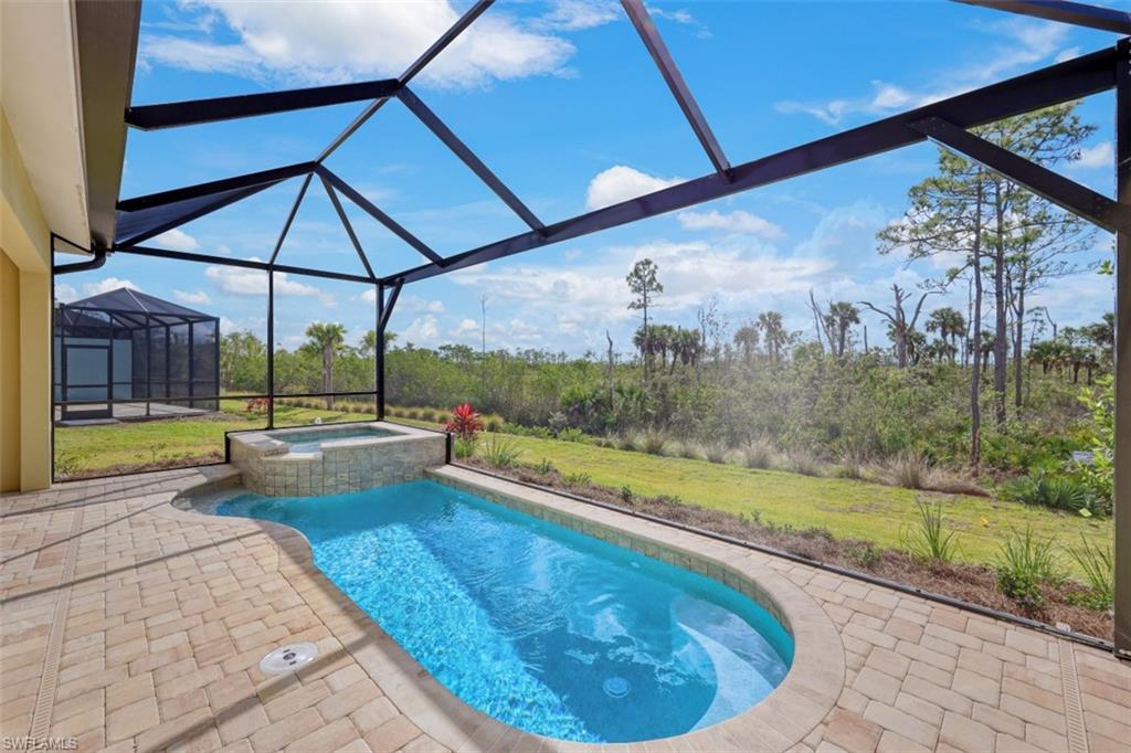 6435 Negril Isle Drive Naples, FL 34113 - Photo 32 of 35 a view of a swimming pool with a porch
