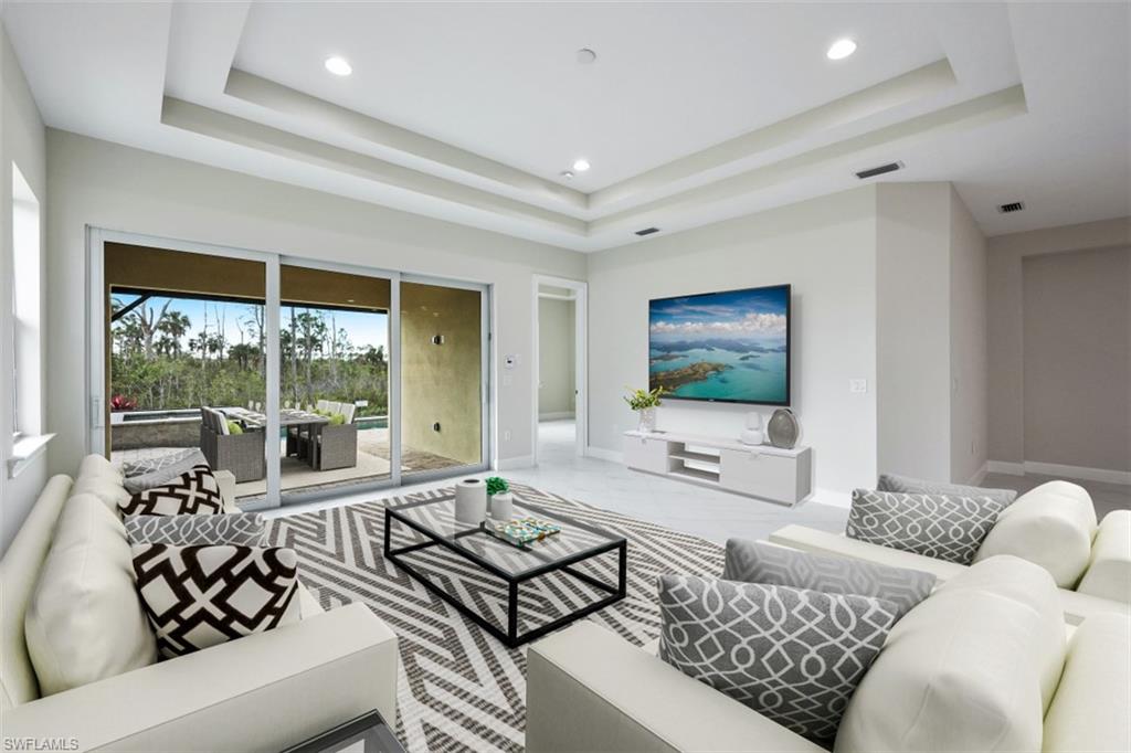 6435 Negril Isle Drive Naples, FL 34113 - Photo 5 of 35 a living room with furniture and a flat screen tv