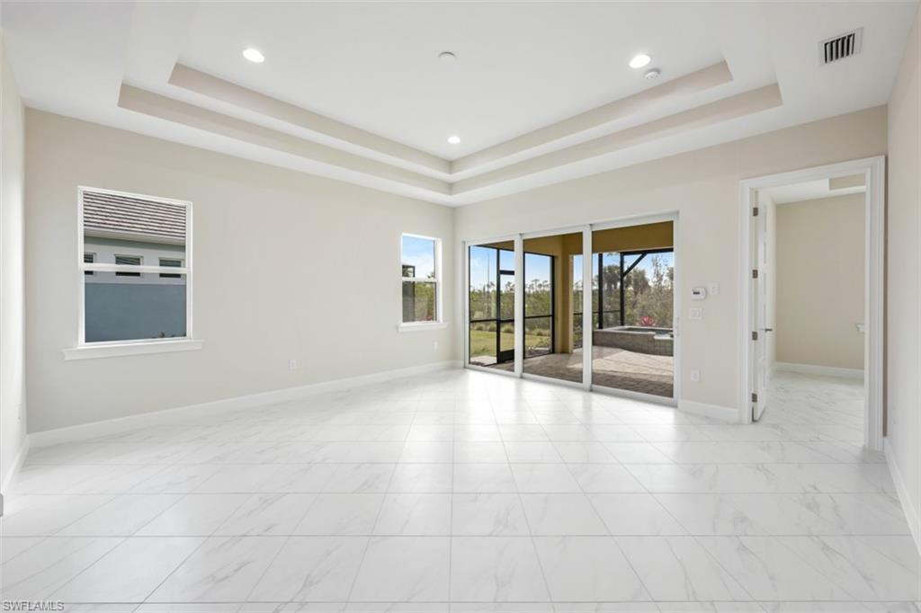 6435 Negril Isle Drive Naples, FL 34113 - Photo 7 of 35 a view of an empty room with glass door