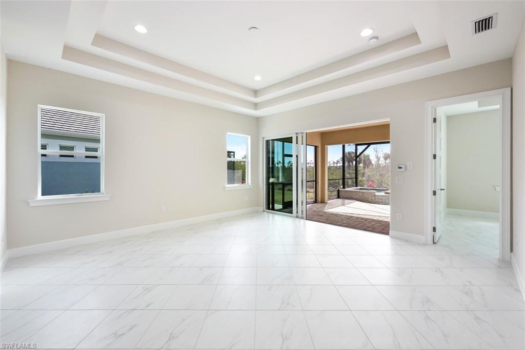 6435 Negril Isle Drive Naples, FL 34113 - Photo 9 of 35 a view of an empty room with glass door