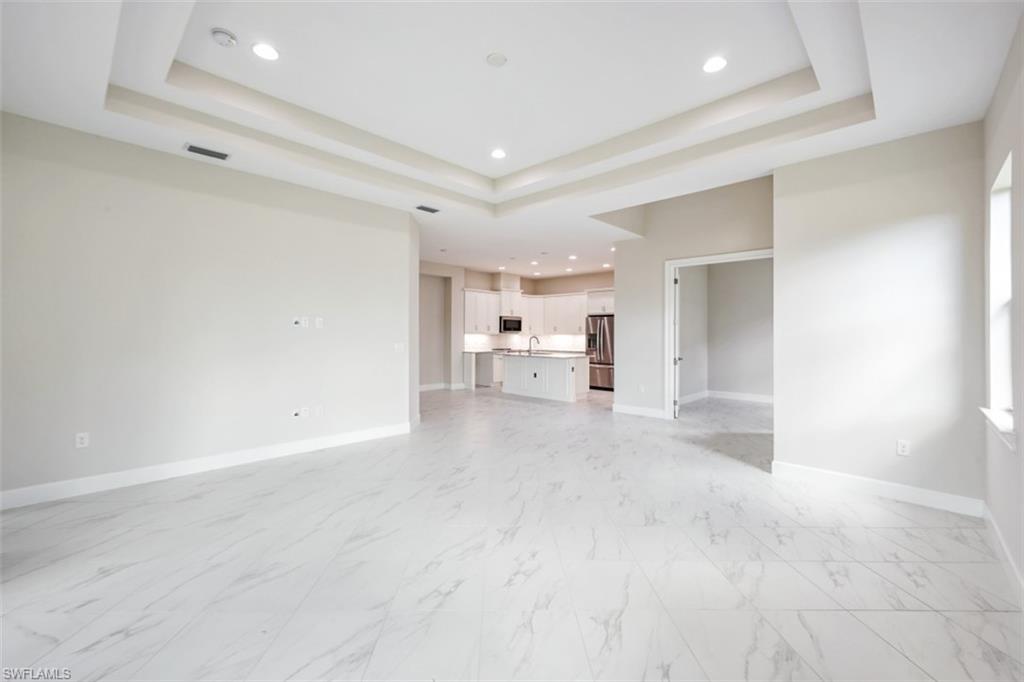 6435 Negril Isle Drive Naples, FL 34113 - Photo 10 of 35 a view of a livingroom and a kitchen