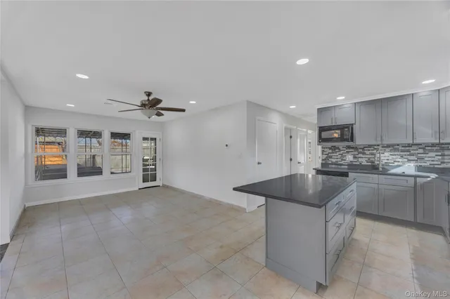 a kitchen with stainless steel appliances granite countertop a sink and a refrigerator