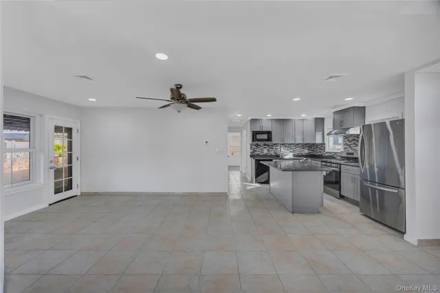 a view of kitchen with stainless steel appliances refrigerator oven microwave and stove