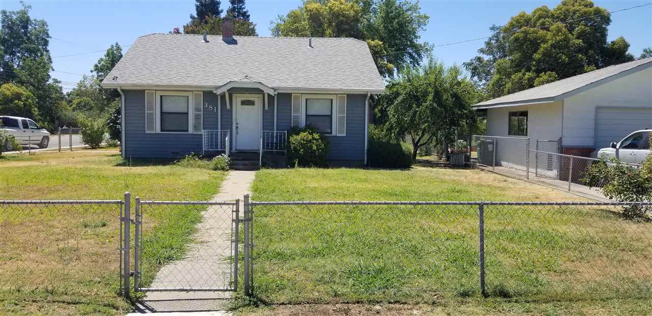 381 Aleut Street Biggs, CA 95917 - Photo 1 of 35 a front view of a house with a garden