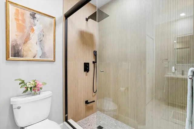 a bathroom with a toilet sink and shower