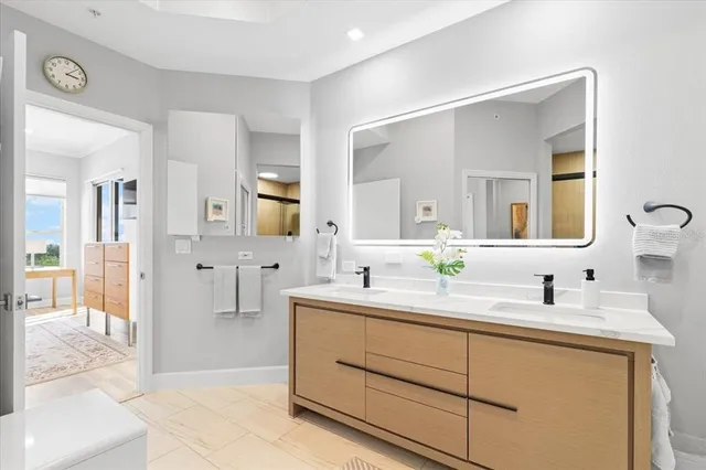 a bathroom with a double vanity sink mirror and