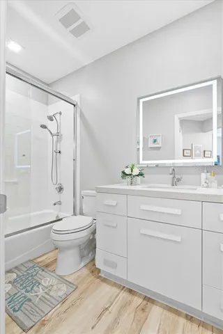 a bathroom with a sink toilet and shower