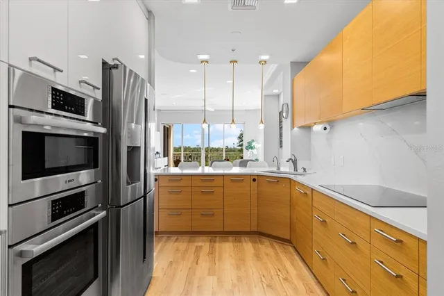 a kitchen with stainless steel appliances a stove sink and microwave
