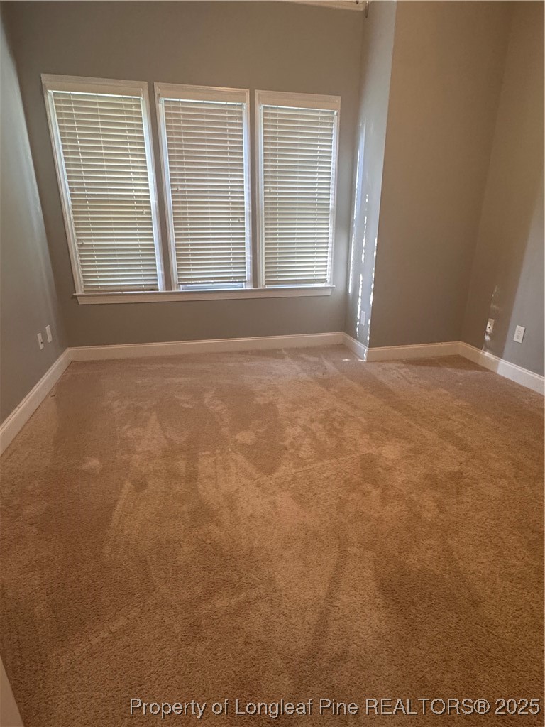 2661 Lockwood Road, Unit 103 Fayetteville, NC 28303 - Photo 11 of 26 an empty room with wooden floor and windows