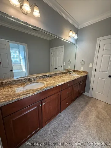 a view of an empty room with furniture and a window