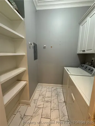 a room with a washing machine and cabinets