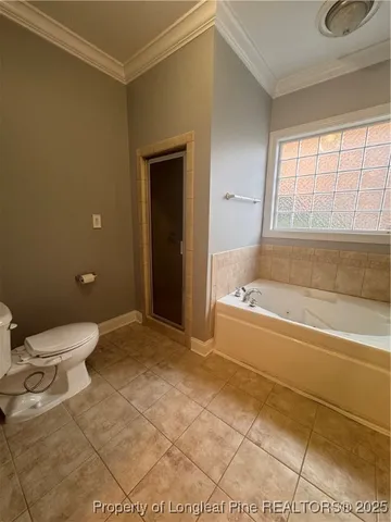 a bathroom with a granite countertop bathtub and toilet