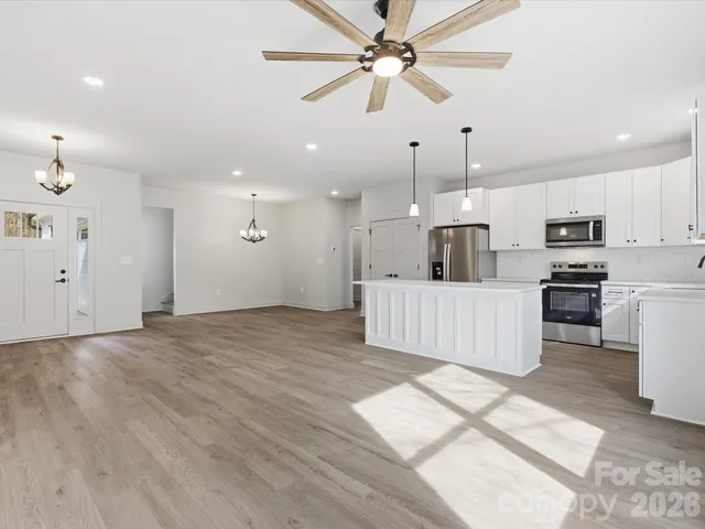 a view of kitchen with sink microwave and refrigerator