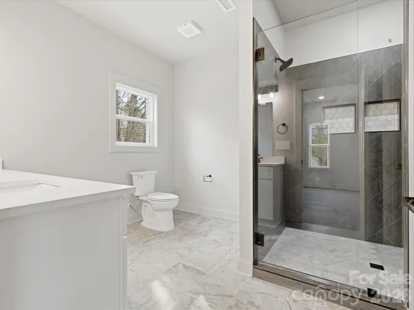 a bathroom with a toilet sink and shower